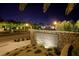 Elegant stone entrance sign for Tuscany Village and Golf, illuminated at night at 677 Viale Machiavelli Ln, Henderson, NV 89011