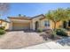 Charming single-story home featuring a brick driveway and well-manicured landscaping in a sunny neighborhood at 677 Viale Machiavelli Ln, Henderson, NV 89011