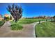 Expansive green space with walking path, landscaping, and manicured lawn in a vibrant community at 677 Viale Machiavelli Ln, Henderson, NV 89011