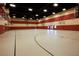 Spacious gymnasium features basketball hoops, court markings, and ample space for recreational sports and activities at 677 Viale Machiavelli Ln, Henderson, NV 89011