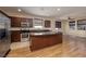 Modern kitchen with stainless steel appliances, granite countertops, and a large center island at 677 Viale Machiavelli Ln, Henderson, NV 89011