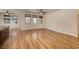 Spacious living room featuring wood floors, neutral walls, and plenty of natural light at 677 Viale Machiavelli Ln, Henderson, NV 89011