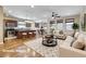 Bright and airy living room and kitchen area with hardwood floors and modern furnishings at 677 Viale Machiavelli Ln, Henderson, NV 89011