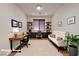 Dedicated office space with built-in shelves, modern desk, and a comfortable seating area at 677 Viale Machiavelli Ln, Henderson, NV 89011
