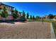 Sand volleyball court with net and trees, ideal for outdoor games and community recreation at 677 Viale Machiavelli Ln, Henderson, NV 89011
