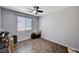 Bedroom with ceiling fan, window, and hardwood flooring at 6773 Bristle Falls St, Las Vegas, NV 89149