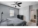 Comfortable bedroom with carpet floors, ceiling fan, and large window for natural light at 6773 Bristle Falls St, Las Vegas, NV 89149