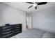 Bedroom featuring neutral paint, black dresser, ceiling fan, and an open doorway at 6773 Bristle Falls St, Las Vegas, NV 89149