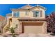 Two-story home boasting a two-car garage, stone accents, and a well-maintained front yard at 6773 Bristle Falls St, Las Vegas, NV 89149