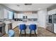 Bright kitchen featuring white cabinets, a tile backsplash, and a large center island at 6773 Bristle Falls St, Las Vegas, NV 89149