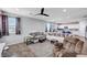 Expansive living room featuring hardwood floors, modern furnishings, and access to a well-equipped kitchen at 6773 Bristle Falls St, Las Vegas, NV 89149