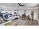 Spacious living room featuring hardwood floors, modern ceiling fan, and ample natural light at 6773 Bristle Falls St, Las Vegas, NV 89149