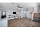 Living area with wood floors, floating shelves, and staircase with a pet gate at 6773 Bristle Falls St, Las Vegas, NV 89149