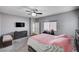 Primary bedroom features neutral carpet, ceiling fan, and a sliding barn door at 6773 Bristle Falls St, Las Vegas, NV 89149