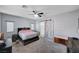 Primary bedroom with a barn door, carpet, ceiling fan, and bedside tables at 6773 Bristle Falls St, Las Vegas, NV 89149