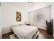 Cozy bedroom showcasing white walls, wood floors, large window and modern décor at 7633 Alexander Hills St, Las Vegas, NV 89139