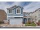 Charming two-story home with blue siding, a two-car garage, and well-maintained landscaping at 7633 Alexander Hills St, Las Vegas, NV 89139