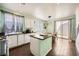Well-lit kitchen features an island, modern appliances, and a view of the backyard at 7633 Alexander Hills St, Las Vegas, NV 89139