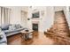 Open living area with hardwood floors, a fireplace, and stairs leading to the second floor at 7633 Alexander Hills St, Las Vegas, NV 89139
