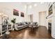 Spacious living room featuring high ceilings, a cozy fireplace, and neutral décor at 7633 Alexander Hills St, Las Vegas, NV 89139