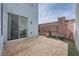 Back patio featuring stamped concrete, seating, and access to the home via a sliding glass door at 7633 Alexander Hills St, Las Vegas, NV 89139