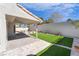 Backyard features a covered patio and artificial turf, providing a low-maintenance and attractive outdoor space at 80 Sea Holly Way, Henderson, NV 89074