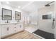 Modern bathroom featuring double vanity, frameless shower, and a large window at 80 Sea Holly Way, Henderson, NV 89074