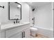 Elegant bathroom featuring white quartz counters, black fixtures, and a shower-over-tub combination with white tiles at 80 Sea Holly Way, Henderson, NV 89074