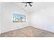 A cozy bedroom features a ceiling fan and a bright window that floods the room with natural light at 80 Sea Holly Way, Henderson, NV 89074