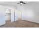Spacious carpeted bedroom featuring ceiling fan, en-suite bathroom, and a walk-in closet for ample storage at 80 Sea Holly Way, Henderson, NV 89074