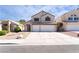Two-story home featuring a two-car garage, neutral stucco, and low-maintenance desert landscaping at 80 Sea Holly Way, Henderson, NV 89074