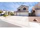Two-story home with desert landscaping, a two-car garage, and a paved driveway at 80 Sea Holly Way, Henderson, NV 89074