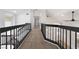 Hallway with black railings overlooking the foyer below, providing an open and airy feel at 80 Sea Holly Way, Henderson, NV 89074