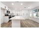 Contemporary kitchen with a white countertop island, stainless appliances, and sleek cabinetry at 80 Sea Holly Way, Henderson, NV 89074