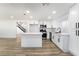 Stylish kitchen with stainless steel appliances, waterfall countertop island, and an open floor plan at 80 Sea Holly Way, Henderson, NV 89074