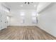 Bright, airy living space with wood-look floors, high ceilings, and large windows at 80 Sea Holly Way, Henderson, NV 89074