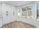 Bright living room with wood floor, large window, and storage cabinets at 80 Sea Holly Way, Henderson, NV 89074