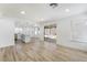 Bright living area features a slider door to the backyard, and opens to a kitchen with white cabinetry at 80 Sea Holly Way, Henderson, NV 89074