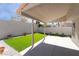 Covered patio area featuring artificial grass and concrete flooring, perfect for outdoor living at 80 Sea Holly Way, Henderson, NV 89074