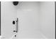 Sleek white shower with contemporary black fixtures, offering a minimalist and modern aesthetic at 80 Sea Holly Way, Henderson, NV 89074