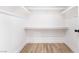 Bright, spacious walk-in closet featuring hardwood floors and custom shelving with plenty of room for storage and organization at 80 Sea Holly Way, Henderson, NV 89074