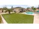 Expansive backyard featuring artificial turf, pool, and ample space for outdoor activities at 8369 Eagle Estates Ct, Las Vegas, NV 89131