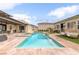 Large backyard boasts a pool, spa, outdoor kitchen, covered patio, and lounge seating at 8369 Eagle Estates Ct, Las Vegas, NV 89131