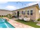 Backyard oasis featuring a pool, comfortable seating, and a stone-accented home exterior at 8369 Eagle Estates Ct, Las Vegas, NV 89131