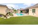 Lush backyard with pool, outdoor seating, fire pit, and meticulously landscaped grounds at 8369 Eagle Estates Ct, Las Vegas, NV 89131