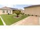 A backyard featuring artificial turf, desert landscaping, and inground pool in the background at 8369 Eagle Estates Ct, Las Vegas, NV 89131