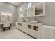 Elegant bathroom featuring double sinks with abundant storage, complemented by a vanity table and drawers for beauty at 8369 Eagle Estates Ct, Las Vegas, NV 89131