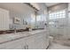 Bathroom with a dual sink marble vanity and glass shower at 8369 Eagle Estates Ct, Las Vegas, NV 89131