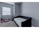 Cozy bedroom featuring a daybed with stylish black upholstery and soft gray walls at 8369 Eagle Estates Ct, Las Vegas, NV 89131