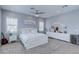 This spacious bedroom features neutral decor, plush carpet, and a tufted headboard for a stylish and comfortable retreat at 8369 Eagle Estates Ct, Las Vegas, NV 89131